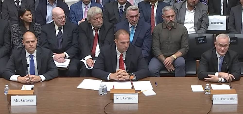 Three witnesses seated at a witness table in a congressional hearing room.